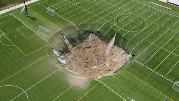 Campo de futebol colapsa e provoca cratera com dezenas de metros 